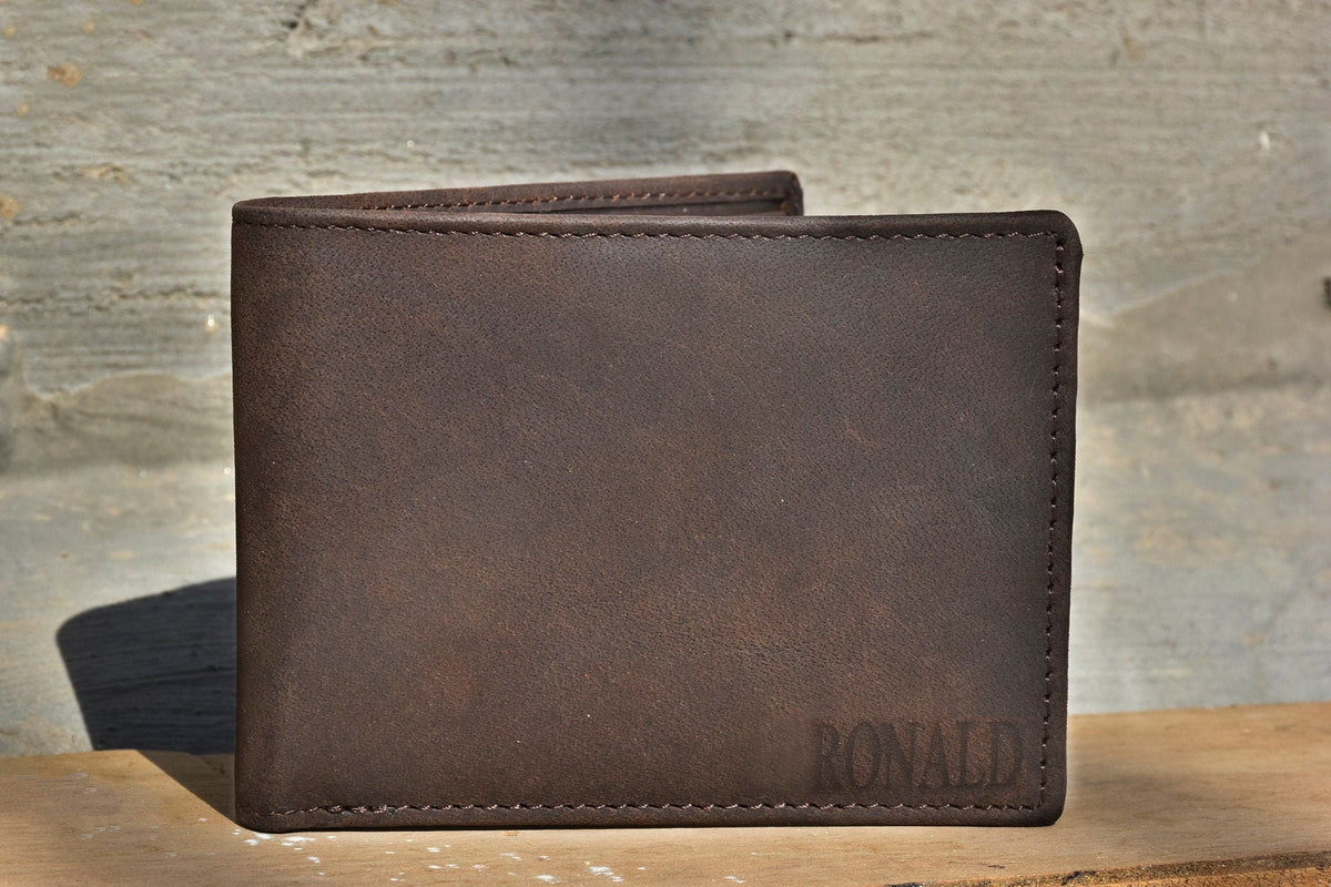 May include: A brown leather wallet with the name "RONALD" embossed on the front.