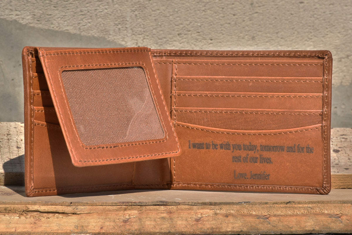 May include: A brown leather wallet with a clear plastic window for a photo ID. The wallet has multiple card slots and a pocket for cash. The inside of the wallet is engraved with the message "I want to be with you today, tomorrow and for the rest of our lives. Love, Jennifer."