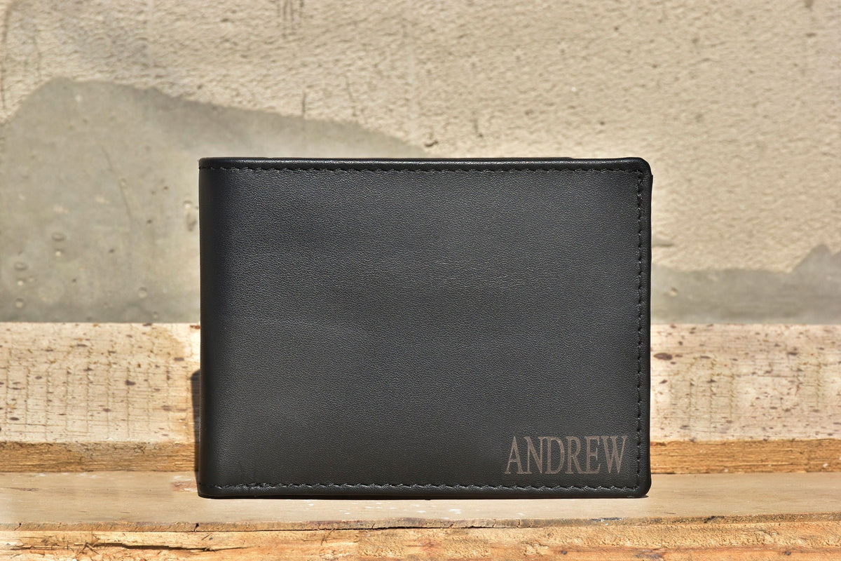 May include: A black leather wallet with the name "ANDREW" embossed on the front.