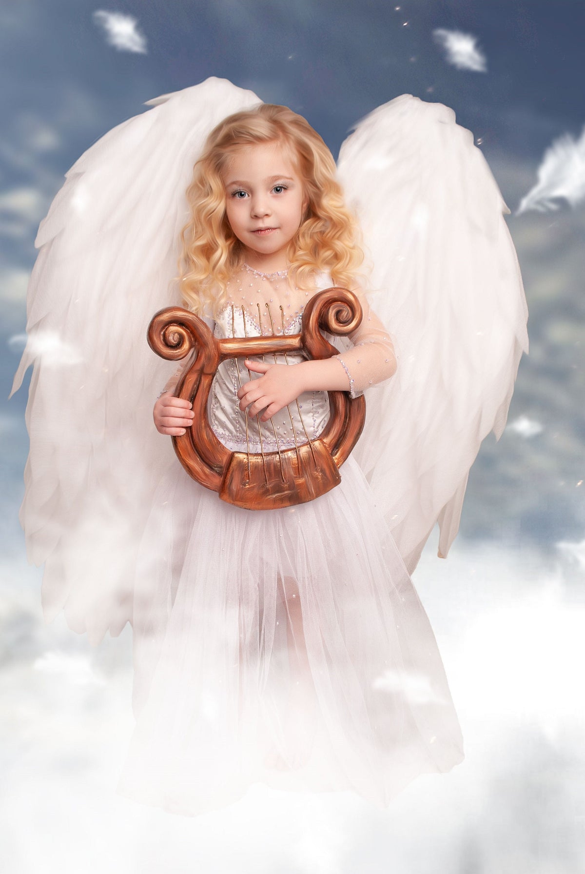 May include: A young girl dressed as an angel with large white wings holds a golden lyre in front of a cloudy blue sky background.