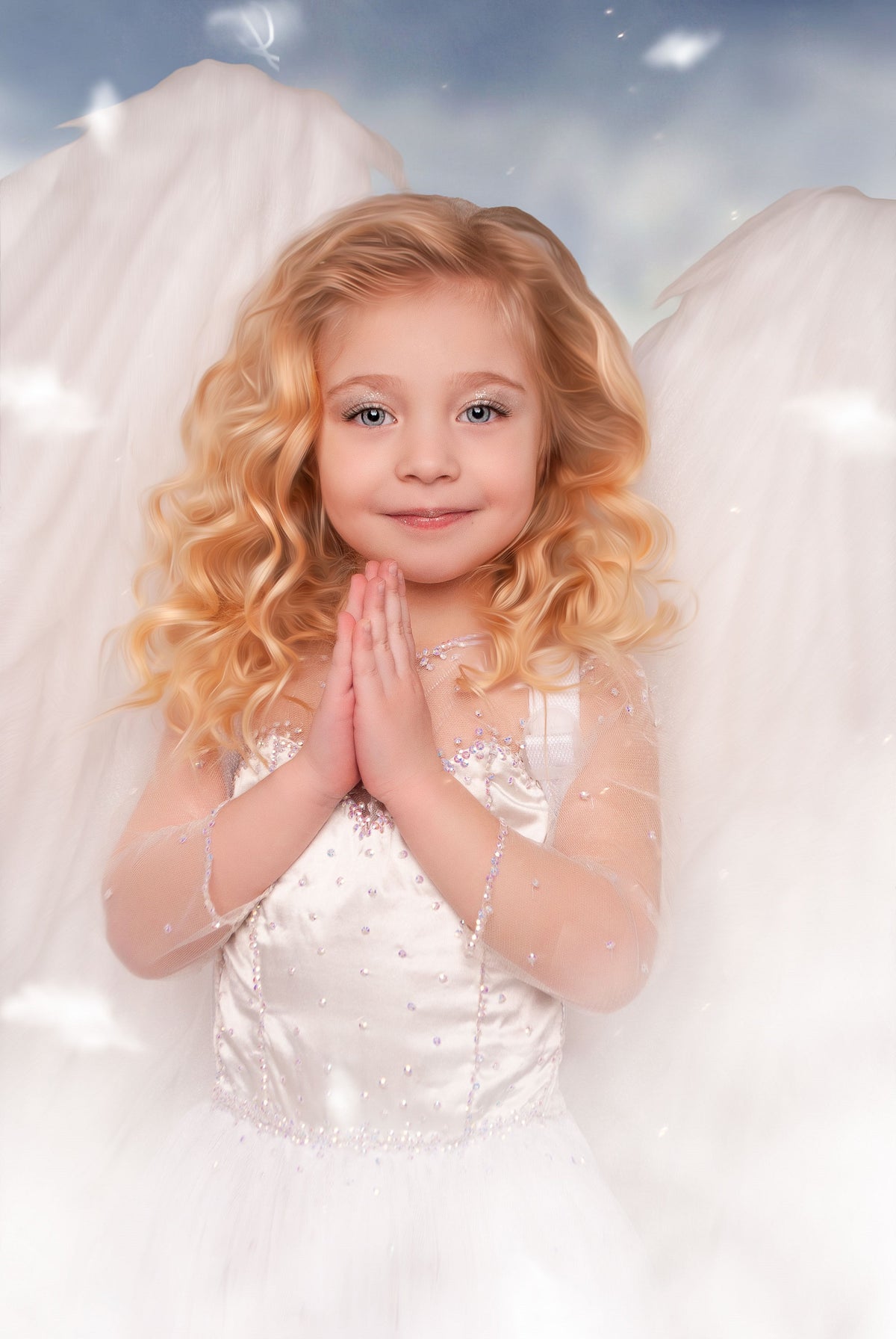 May include: A child with wavy blonde hair wearing a white sleeveless dress with sheer long sleeves and bodice embellishments, featuring large white feathered wings attached to the back, with hands pressed together in a prayer-like gesture.