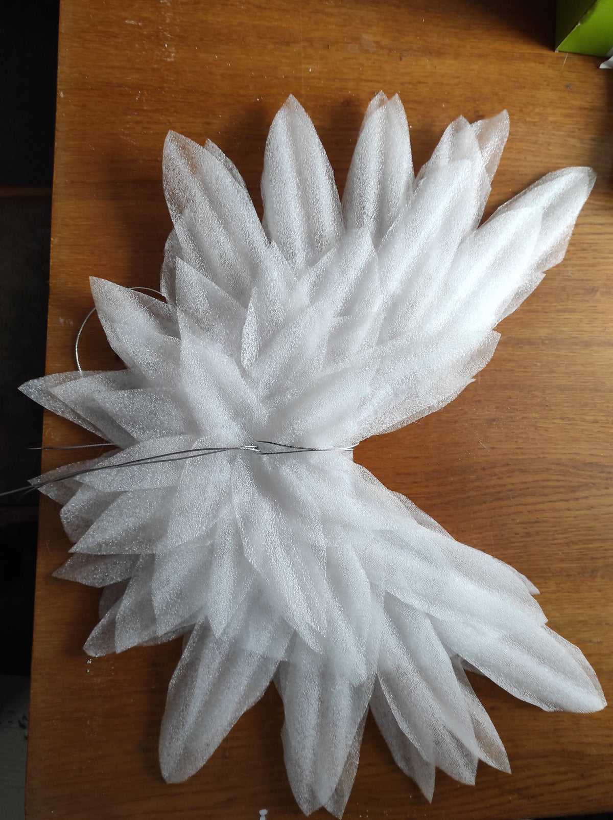 May include: White foam angel wings with wire attached to the center.