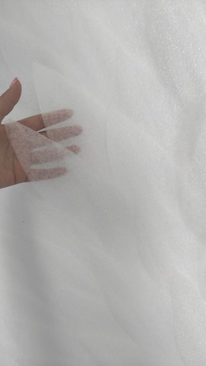 May include: White tulle fabric with a soft, delicate texture. The fabric is sheer and lightweight, making it ideal for crafting and sewing projects.