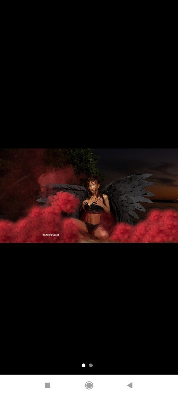 May include: A woman with black wings poses in front of a red smoke cloud. She is wearing a black bra and underwear.
