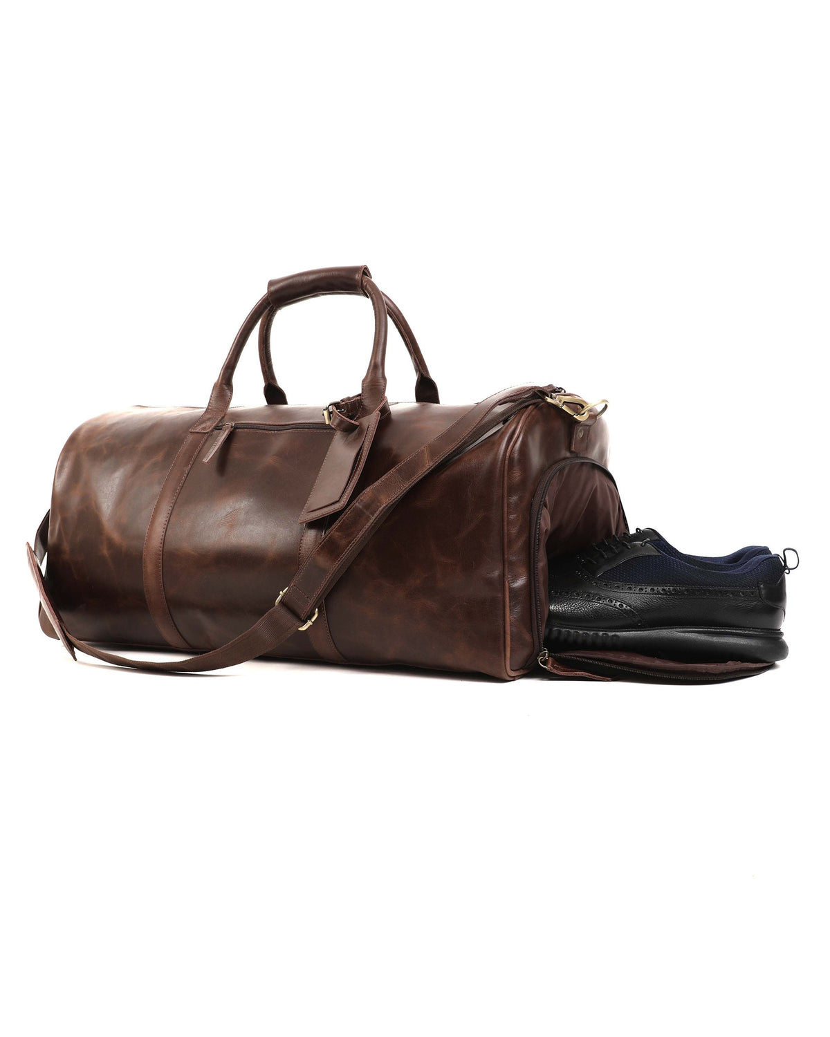 May include: A brown leather duffel bag with a separate shoe compartment. The bag has a top handle, a shoulder strap, and a pair of black and blue shoes inside the shoe compartment. The bag is designed for travel and has a classic look.
