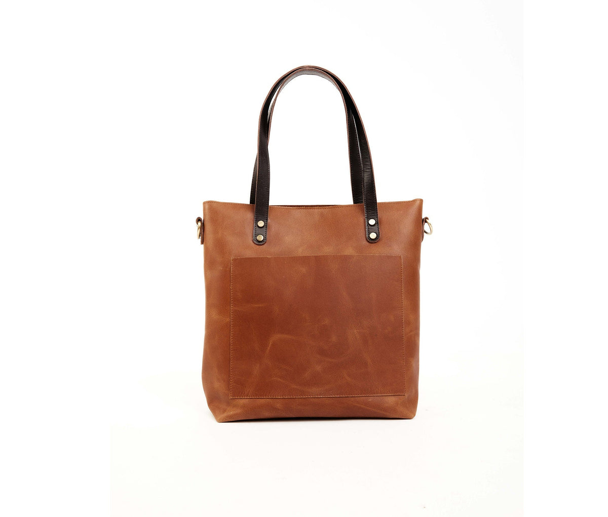 May include: A brown leather tote bag with black leather handles and a front pocket. The bag has a gold metal zipper pull and a gold metal buckle.