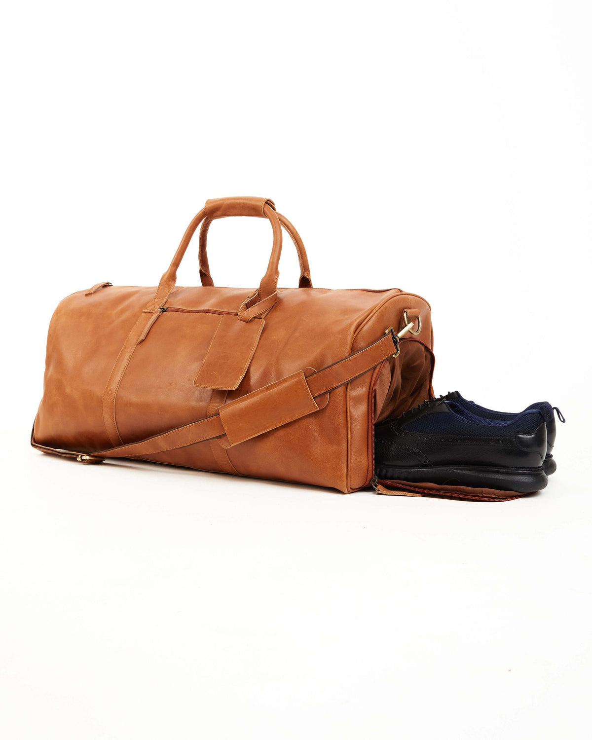 May include: A brown leather duffel bag with a zippered compartment and a shoe compartment. The bag has a top handle and a shoulder strap.
