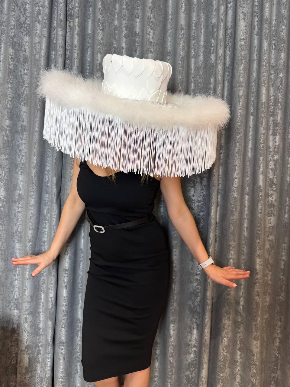 May include: A white wide-brimmed hat with a feathered trim and fringe. The hat is made of a textured material and has a unique design.