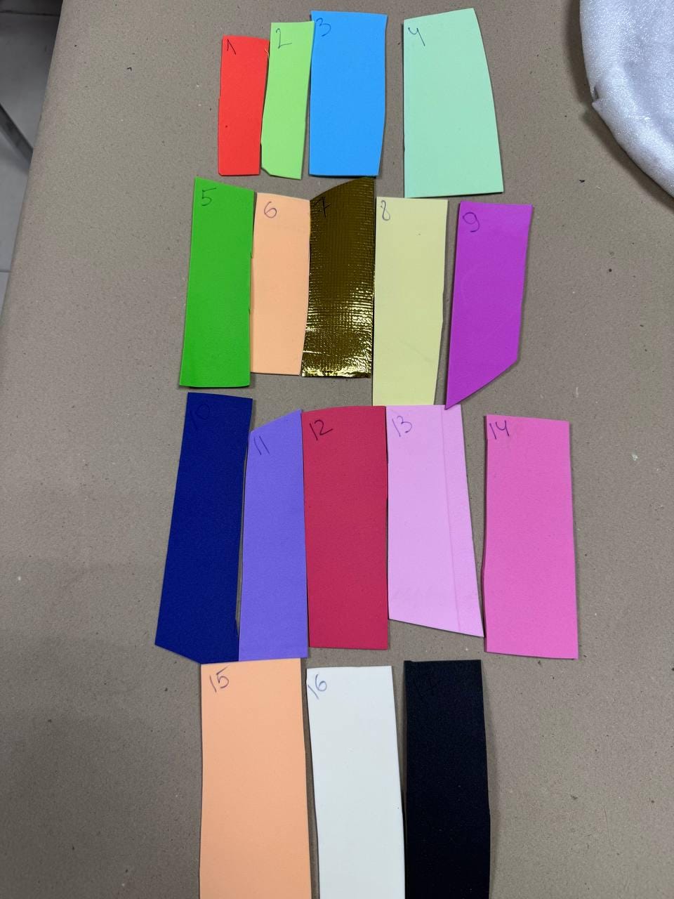 May include: A collection of sixteen rectangular color swatches in various shades, including red, green, blue, and pink. The swatches are arranged in rows and columns, showcasing a range of hues for design or crafting purposes.