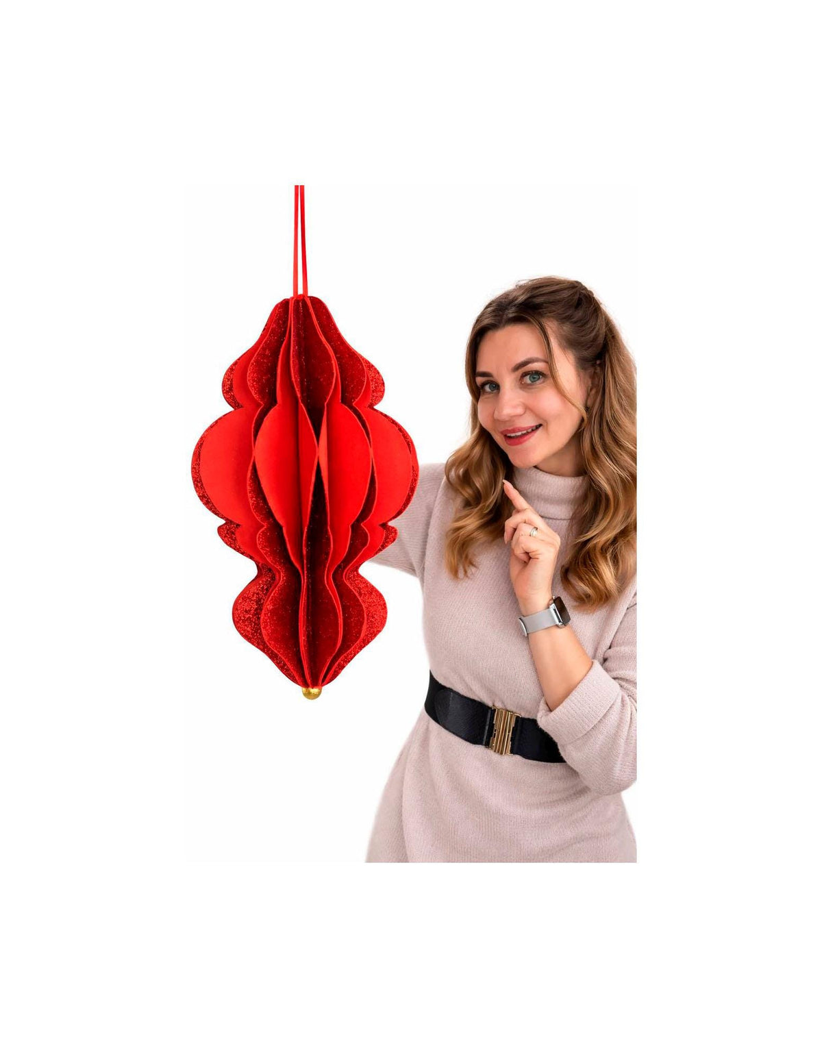 May include: A large, red, paper honeycomb ornament with a glittery texture and a gold-colored bead at the bottom. The ornament is suspended by a red string. The ornament has a unique, layered design.