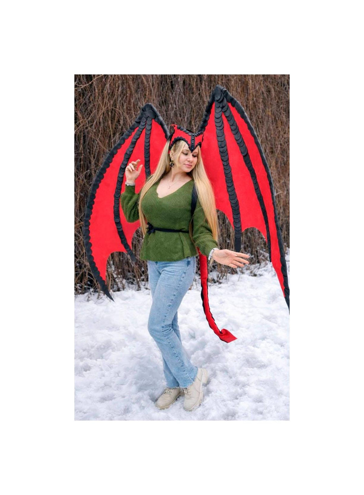 May include: Red and black dragon wings with a matching headband and tail. The wings have a black scalloped edge and a bright red interior. The tail is red and the headband is black and red. The costume is worn with a green sweater and blue jeans.