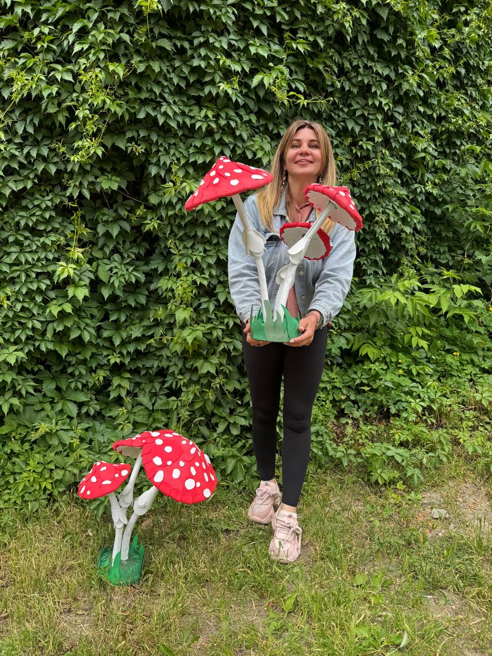 May include: Two sets of decorative mushroom sculptures featuring bright red caps with white spots and white stems. Each set consists of three mushrooms of varying sizes attached to a green base, designed for display as standalone garden decor.