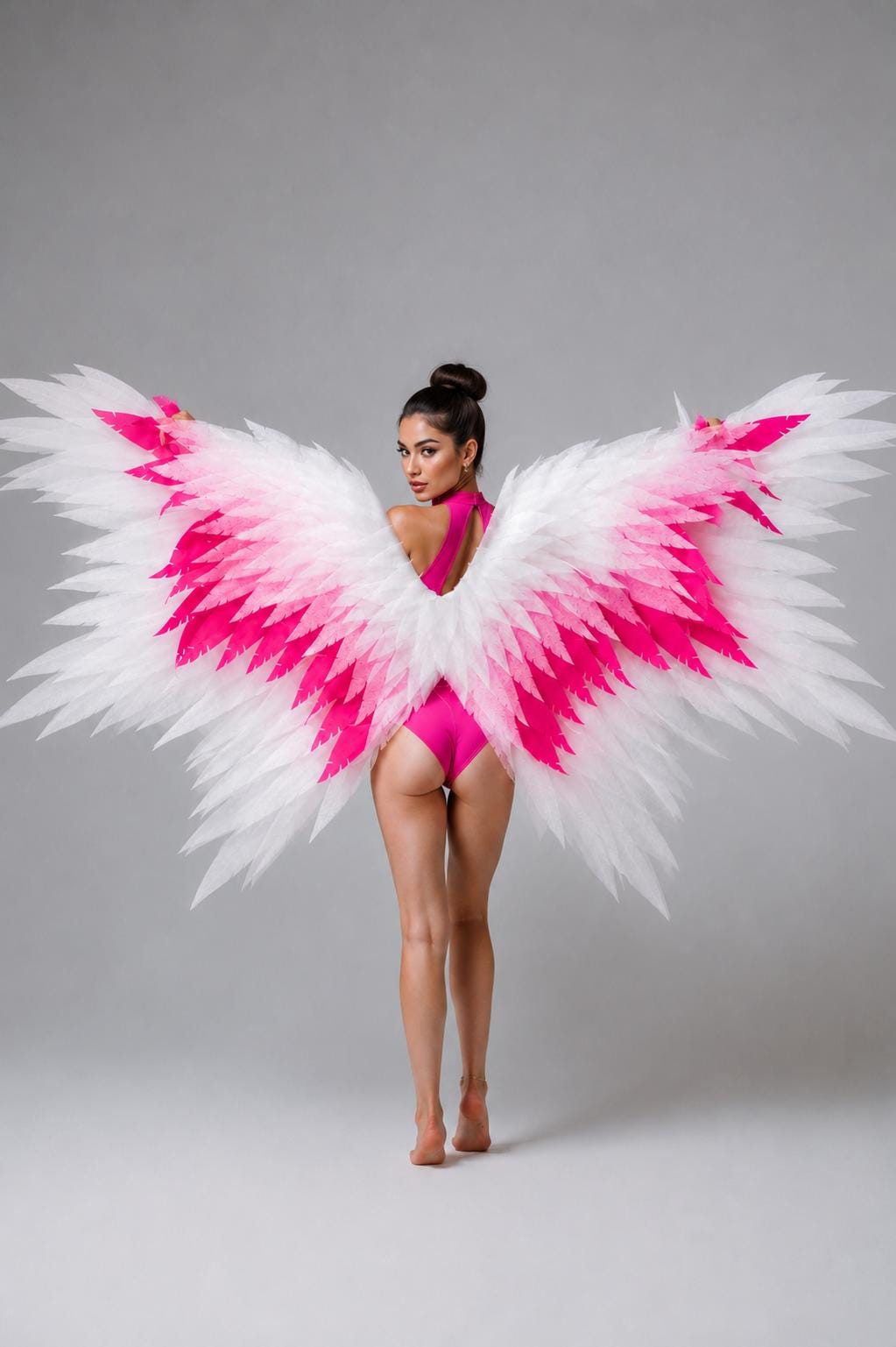 May include: Large decorative wings featuring a layered feather design with a gradient color scheme transitioning from white at the tips to vibrant hot pink at the base. The wings are wide and expansive, showcasing a detailed, pointed feather structure.